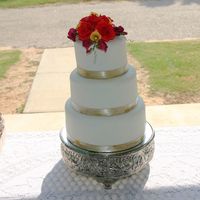 My First Wedding Cake White almond sour cream with raspberry filling. Gumpaste flower topper. Thanks for looking!