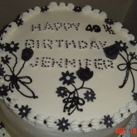 50 Birthday Choc cake with extra choc chips, butter cream frosting, letters and flowers are made from fondant.