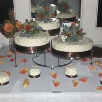 Sarahs_Cake.jpg Three seperate cakes frosted with cream cheese frosting and vanilla cake, topped with fresh flowers.