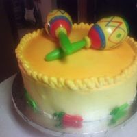 Fiesta!! Very loud fun cake!!!! Haha. The accents are party favors, the icing is buttercream, sprayed with yellows and oranges!