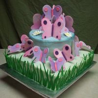 Butterfly Cake Yellow cake with buttercream icing. The grass blades are fondant, as well as the butterflies. The daisies are made out of royal icing....