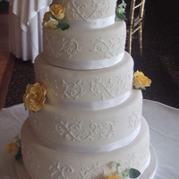 Opal-Innocence Inspired White piping on ivory fondant with hand-sculpted flowers.