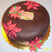 Chocolate Cake With Pointsetias Never try to paint red gel on a chocolate fondant cake..lol I had to paint it 3 times, I gave up and just tried to fill them in with icing...