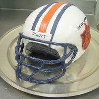 Auburn University Helmet 3 10" Chocolate cakes and a 9" chocolate cake stacked with buttercream and carved into a round shape. The outside is covered in...