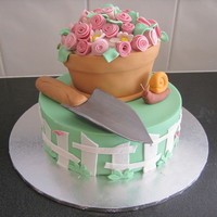 Garden Party An 8" mud cake covered in fondant and 6" carved flower pot. I made this for my friends garden party.