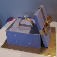 Ring Box Engagement cake made out of mud cake covered in choc ganache. The lid and diamond are not edible.