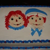 Raggedy Ann And Andy This is a chocolate cake iced in buttercream. I hand painted the faces on fondant . I accented with MMF and buttercream.