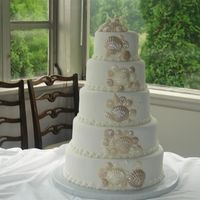 Beach Theme Wedding Cake This is my second wedding cake. I am really pleased with how this one turned out. It is Satin Ice fondant and chocolate seahsells coated in...