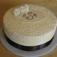 Bridal Shower This cake is buttercream with a fondant medallion in the center that I hand painted the monogram of the bride and groom. Accented with...