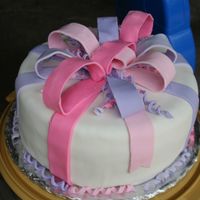 Present To Eat 10" round with rasberry jam filling. Satin Ice fondant flavored w/ almond. This was my first attempt at a present cake, definitely...