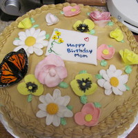 Mother's Garden Chocolate cake with white chocolate buttercream icing. I used a recipe I found here on CC! The flowers are all made of fondant, and hand...