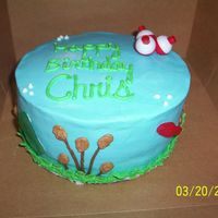 100_1454.jpg this cake has gummy fish on the side with fishing bobbers on the top.