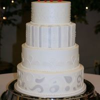 Traditional With A Touch Of Modern Round four-tier wedding cake iced in buttercream with fondant accents and gumpaste monogram