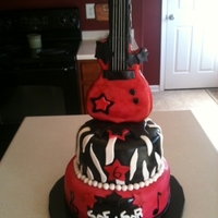 Rock Star Guitar Cake This was for a Rock Star party. chocolate cake, covered in MMF, with MMF accents. Guitar is RKT, covered in chocolate candy coating, then...