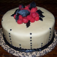 Mocha Raspberry Mocha Cake with Raspberry filling. Mocha fondant and fresh raspberries with royal icing detail.