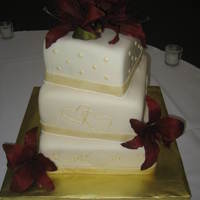 Gold Wedding 3 tier fondant covered. RI designs painted gold. Silk Flowers.