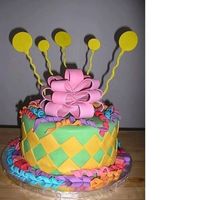 Curly Q's Cake Curly Q's, miniature presents, diamond cutouts, bow and balloons....