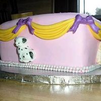 Puppy Cake White cake w/ strawberry filling, covered in Satin Ice. Puppies, Swags and Bows also made from Satin Ice. Pearl boarder completes cake.