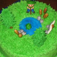 Img_0003.jpg supreme lemon pound cake with buttercram frosting fisherman fish and rocks are fondant and trees are royl icing pond is wiltons gel