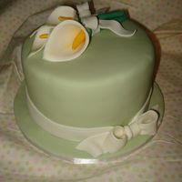 Calla Lily Cake This is a 6" round caramel cake with bavarian cream filling. Covered with Michelle Foster's Fondant. Lilies and bows are made...
