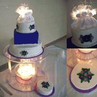 3-Tiered Mixed Shape Purple Flower Wedding Cake bottom layer: chocolate cake, middle layer: red velvet cake, top layer: yellow cake. Buttercream icing and royal icing flowers.