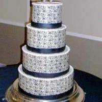 White Chocolate Wrapped Wed Cake This cake was my first chocolate transfer. What an amazing product! Beatuiful, simple, quick, and predictable. The black ribbons are...