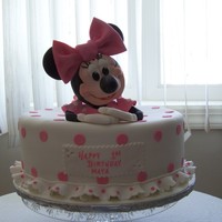 Minnie Mouse Birthday Cake This cake was for a 1-yr old girl. Minnie Mouse was made out of cake and Rise Krispie treats - her head, arms and legs were Rice Krispies....