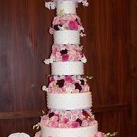 Sitting Atop Roses This cake was all about the flowers! I made the cakes (only one tier was real, the others were styrofoam). The florist did a wonderful job...