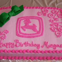 Pink John Deere 1/2 Sheet iced in BC, fondant bow. This cake was for my fourteen year old neice who ask for a pink John Deere cake with a green bow.