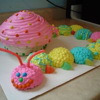 Caterpillar And Mushroom white mini balls and chocolate "mushroom" with whipped cream icing mini m&m's and fruit slices for decoration.