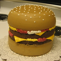 Double Cheeseburger All chocolate cake. Buttercream frosting, added some cocoa powder to achieve bun color. Fondant cheese. Made this for my 6 year old who is...