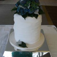 Layered Wedding Cake Three tiered wedding cake with strips of icing wrapped around it.