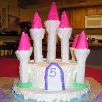 Ice Castle Cake Castle cake with whipped frosting and sparkling sugar.