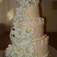 Easter Lily Cake 3 tier, covered in Ivory Fondant, with gumpaste easter lilies. My first 3 tiered cake.