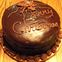 Christmas 2009 Ganache Cake Four layer chocolate cake, white chocolate filling, semisweet ganache coated. I chilled the remaining ganache and mixed it into bc to pipe...