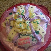 Birthday This is my first time using fondant. I made a traditional white cake with a thick frosting filling. ON THe outside I spread homemade...