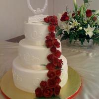 Red Rose Wedding Cake fondant over cream cheese icing. Gumpaste roses, ribbon around each tier.