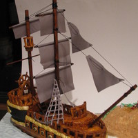 Pirate Ship I made this for an adult birthday party. The ship is vanilla sponge cake with almond icing. The outside of the ship is fondant. I hand...