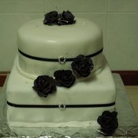 Black And White Wedding This was made for a wedding. It is made of white cake covered in almond flaved butter cream and fondant. The roses are made of sugar paste...