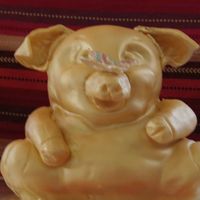 Birthday Cake I created this pig using a 3-d bear pan and rolled fondant. I airbrusher it in gold. The person who ordered it wanted a gold pig to go...