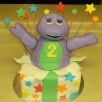 Barney Barney is made out of rice crispy treats covered in fondant. Gift is double chocolate cake covered in BC decorated with fondant.