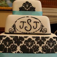 Justins_Wedding_Cake.jpg My first wedding cake attempt, for my brother's wedding. Bride chose design, and I warned her I had no experience with square cakes or...