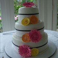 Gerber Daisy Wedding Cake Double chocolate cake with chocolate mousse filling and covered with marshmellow fondant . Bright multi colored gum paste daisies. White...