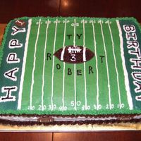 Football Field 1/2 yellow, 1/2 chocolate with all BC icing. Center football is chocolate BC built up to have 3-D effect.