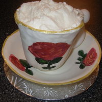 Cup Of Frothy Latte! I made the saucer and teacup by hand out of gumpaste and painted the flowers on it. The cup is full of cake and this serves as a single...