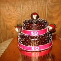 Glazed Cake glazed with butter cream dots and choc. covered strawberries