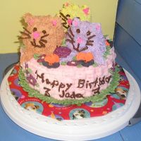 Kitties In A Basket Buttercream cake with royal icing flowers. Flowers don't really match because I was in a hurry and just used whatever I had in stock....