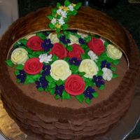 Basket Of Flowers! Co-worker ordered this for her 78 year old mothers b-day. Devil's food cake with chocolate BC. Handle is gum paste. Flowers are royal...