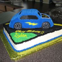 Hot Wheels Cake Base is a 1/2 sheet chocolate cake with buttercream filling and the car is white. All decorating is done in buttercream icing. A special...