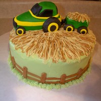 Tractor Cake 10" strawberry cake with cream cheese frosting. Tractor and fence are MMF. For a 2nd birthday party. Got the inspiration from the Cake...